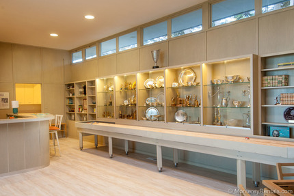 Trophy room, bar, and shuffleboard table